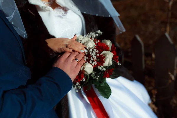 Wedding bouquet in the hands of the bride at the ceremony.