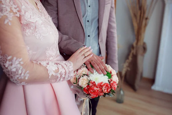 Wedding bouquet in the hands of the bride at the ceremony.