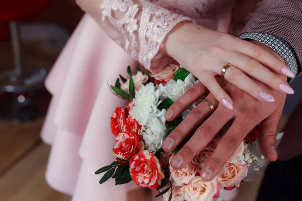 Wedding bouquet in the hands of the bride at the ceremony.