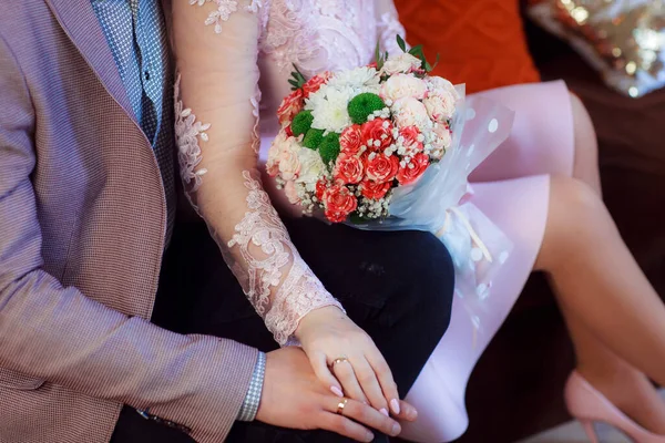 Wedding bouquet in the hands of the bride at the ceremony.