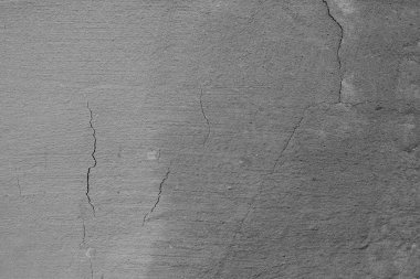 Çatlakları ve çizikleri olan beton bir duvarın dokusu arka plan olarak kullanılabilir.