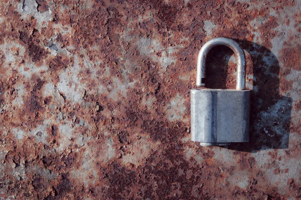 old rusty padlock on a wooden background