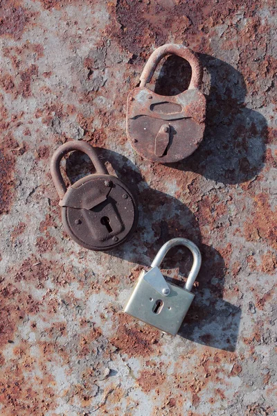 old rusty padlock on a background of a wooden door