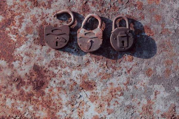 old rusty padlock on a wooden background