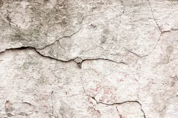 Çatlakları ve çizikleri olan beton bir duvarın dokusu arka plan olarak kullanılabilir.