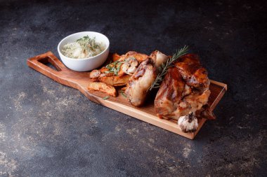 Kemiğin üzerinde büyük bir parça kızarmış et. Josper 'da kızartılmış sarımsak. Büyük parçalar halinde ızgara patates..