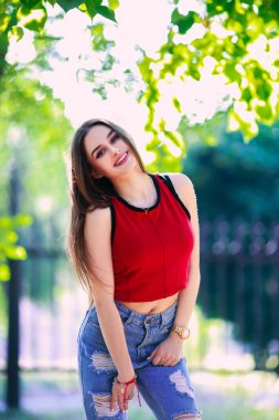 Beautiful serious expression girl with long hair. Summer walking clothes style. The concept of personal care. Happy emotions on the face.