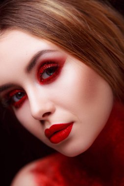 Makeup in the style of beauty. Bright lips and eyes. Portrait of a beautiful young girl. Journal detailed skin retouching. Expressive eyebrows. Huge eyelashes. Neon shadows.