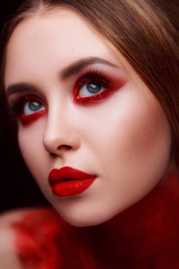 Makeup in the style of beauty. Bright lips and eyes. Portrait of a beautiful young girl. Journal detailed skin retouching. Expressive eyebrows. Huge eyelashes. Neon shadows.