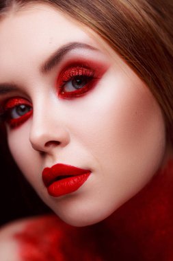 Makeup in the style of beauty. Bright lips and eyes. Portrait of a beautiful young girl. Journal detailed skin retouching. Expressive eyebrows. Huge eyelashes. Neon shadows.