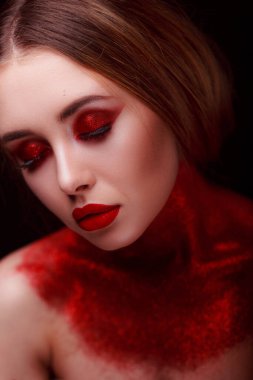 Makeup in the style of beauty. Bright lips and eyes. Portrait of a beautiful young girl. Journal detailed skin retouching. Expressive eyebrows. Huge eyelashes. Neon shadows.