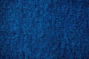 Mavi kot kumaşı. Denim makine dikişi. Harfler ya da tasarım için arkaplan olarak kullanılabilir. Fabrika terziliği. Pamuk kumaş. Kot pantolon moda..