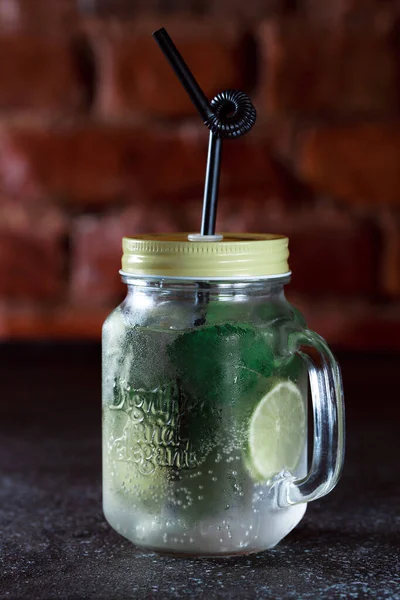 Mojito drink with ice. Trend: cocktail in a can. Refreshing alcoholic cocktail with mint and lime.