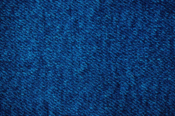 Texture of blue denim. Denim machine stitch. Can be used as background for lettering or design. Factory tailoring. Cotton fabric. Jeans fashion.