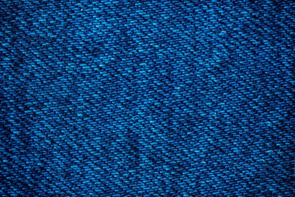 Texture of blue denim. Denim machine stitch. Can be used as background for lettering or design. Factory tailoring. Cotton fabric. Jeans fashion.
