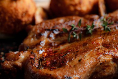 Karamelli soslu hindi bifteği ve siyah tabakta patates köftesi. Baharatlar - biber, maydanoz, fesleğen, kekik, beyaz sarımsak sosu.