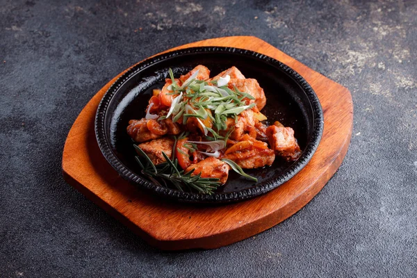 Kızarmış et ve karamelli soslu sıcak tava. Pişmiş ve taze sebzeler garnitür ve garnitür olarak..