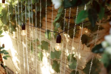 wedding day, decorations with flowers and light bulbs illuminations 