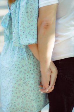 couple in love together holding hands and standing in park 
