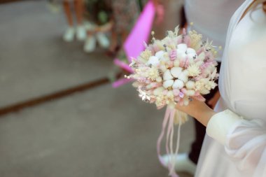 partial view of bride and groom, woman holding flowers bouquet, wedding ceremony 