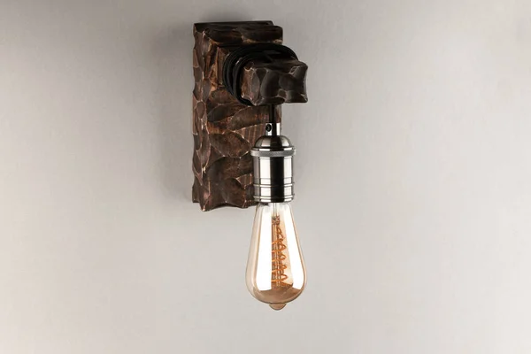 decorative, wooden wall lamp with Edison light bulb