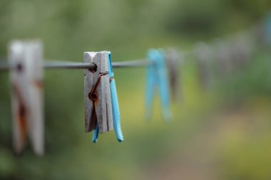 clothespins on rope outdoors, blurred background 