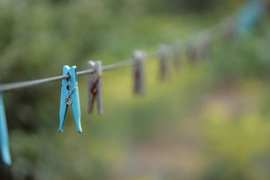 clothespins on rope outdoors, blurred background 