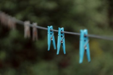 clothespins on rope outdoors, blurred background 