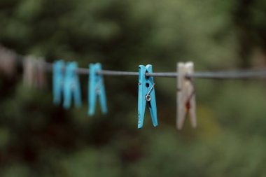clothespins on rope outdoors, blurred background 