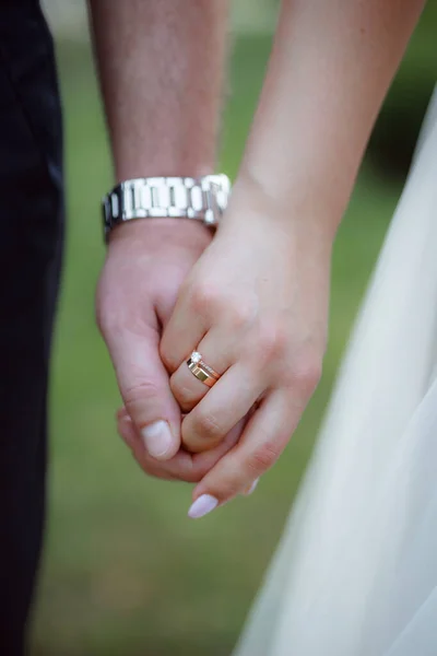 married man and woman holding hands, wedding day