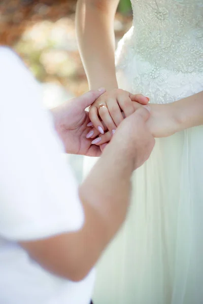 married man and woman holding hands, wedding day