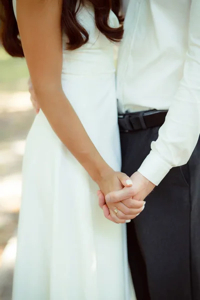 married man and woman holding hands, wedding day