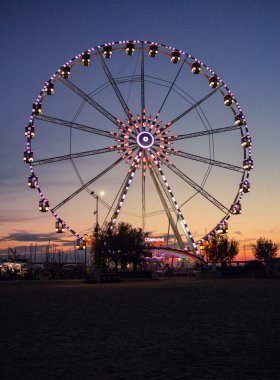 Rimini, Italy 14 July 2020 Colorful Ferris wheel at Sunset at harbour of Rimini, Italy