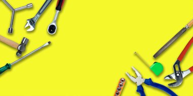 Topview of Different Work Tools on Yellow Background- Stock Photo