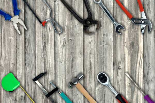 Topview of Different Work Tools on Wood Background- Stock Photo