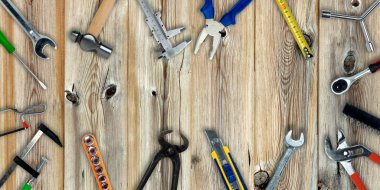 Topview of Different Work Tools on Wood Background- Stock Photo