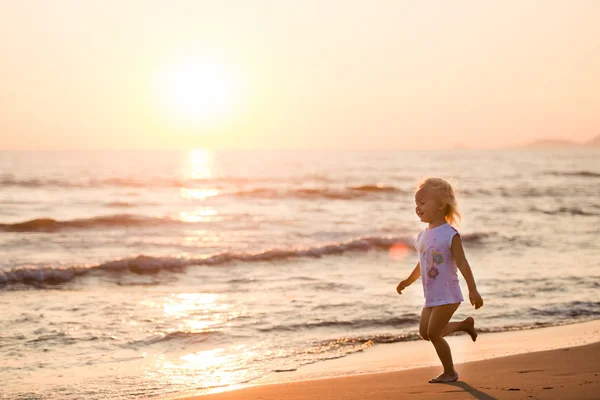 Belle petite fille courant sur une plage au coucher du soleil, Italie, Forte — Photo