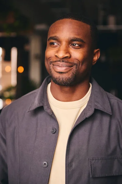 Smiling Young Black Male Standing In Office Looking At Camera
