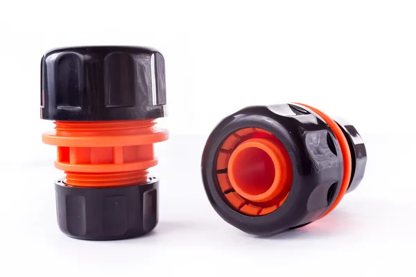 Orange adapter for connection of a garden hose with watering system — Stock Photo, Image