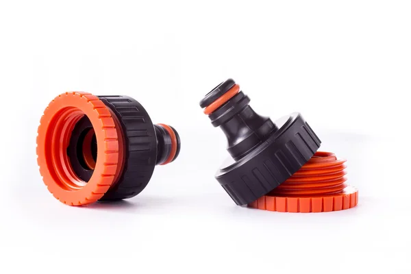 Orange adapter for connection of a garden hose with watering system — Stock Photo, Image