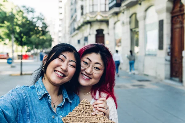 Szczęśliwe Młode Azjatki Luźnych Ubraniach Uśmiechnięte Patrzące Kamerę Podczas Robienia — Zdjęcie stockowe
