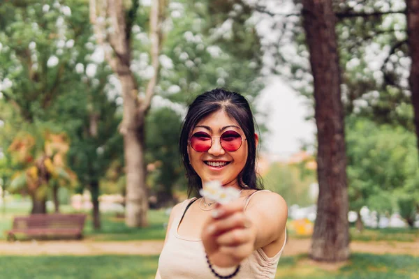 Happy Asian Female Stylish Sunglasses Smiling Giving Small Flower Camera — Foto de Stock