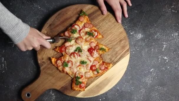 A little girl cuts with a scabbard a hot pizza a Christmas tree on a dark table, top view close-up. Family fun and cooking concept. — Stock Footage Little Girl Cuts Scabbard Hot Pizza Christmas Tree Dark Table Video Clip
