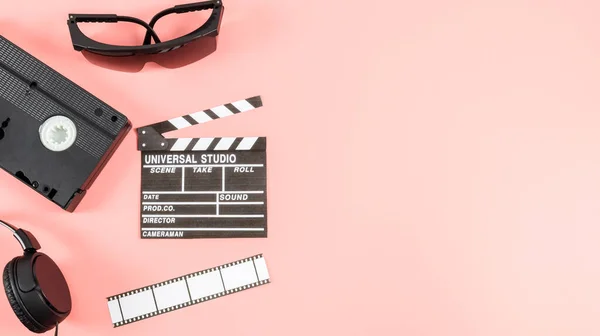 Kino Klappbrett Filmstreifen Videoband Und Kopfhörer Links Vor Rosa Hintergrund — Stockfoto