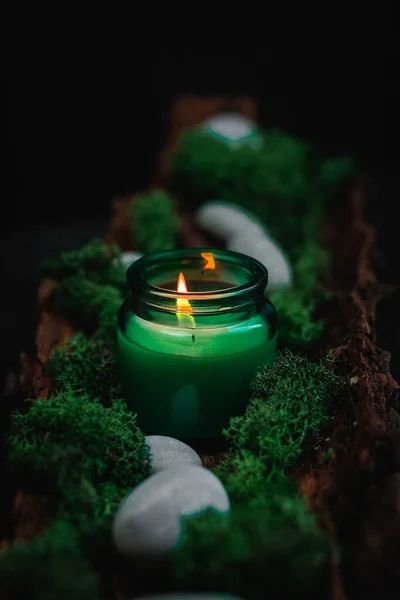White Burning Candle Glass Jar Green Moss Gray Stones Bark — Zdjęcie stockowe