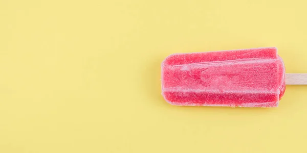 Raspberry Sherbet Wooden Stick Lies Right Yellow Background Copy Space — Stockfoto