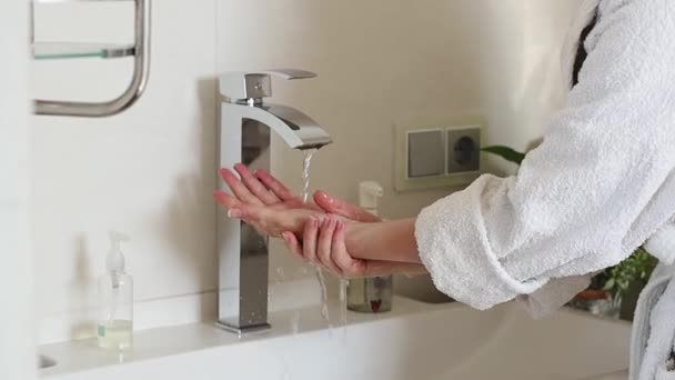 Caucasian Young Woman White Bathrobe Rinses Her Left Hand Stream — Stock Video