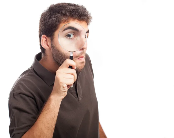 Man looking through magnifying glass — Stock Photo, Image