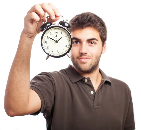 Young man holding alarm clock — Stock Photo, Image