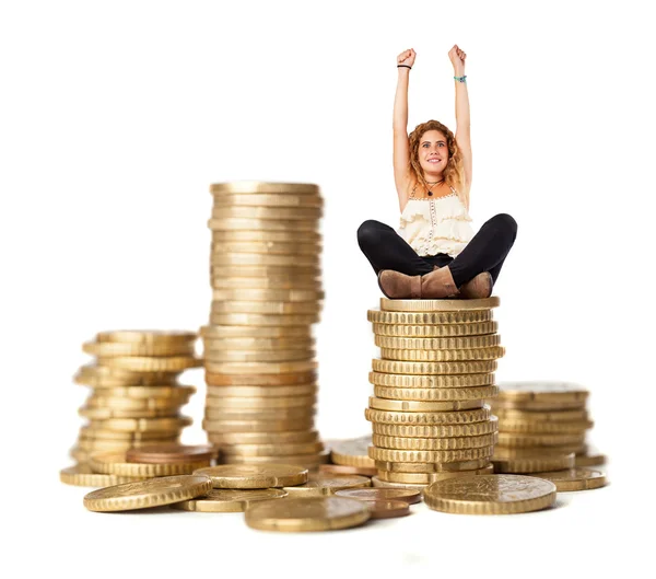 Young woman sitting on coins — Stock Photo, Image